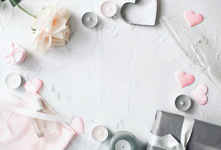 The theme is Valentine's Day. Packed gift, rose and pink hearts with other romantic decoration located around the perimeter of the white background. Free space for text. view from the top point.の写真素材