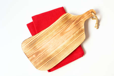 A cutting wooden board and red towel are on a white background in the center of the image. Free...