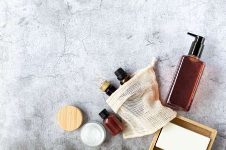 spa and beauty. A set of cosmetics, creams and soap in a wooden soap dish are on a gray background. Free space for text. view from above.の写真素材