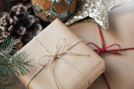 A close-up of Christmas gifts wrapped in elegant paper, surrounded by festive holiday decorations, in a retro style.の写真素材