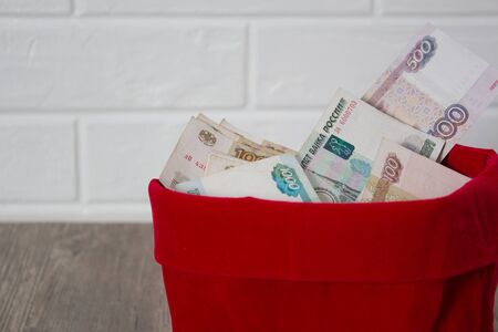 Russian rubles in a red bag. Full bag of money. Banknote, currency, Bank, business, economy, investment. Salary, winnings, prize, stash,の写真素材