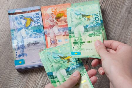 Hands hold a lot of money. Tenge KZT. National currency of Kazakhstan, KZ. Exchange rate. Economy,...