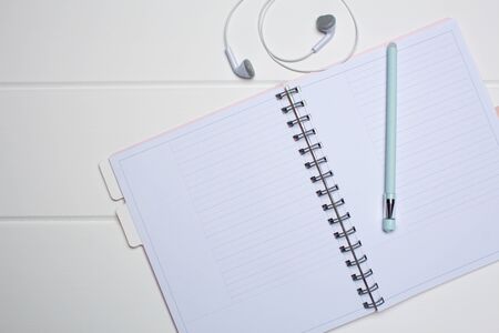 Daily planner on a white wooden background. Close-up, copy space, clear space, mockup. Clean sheet,...