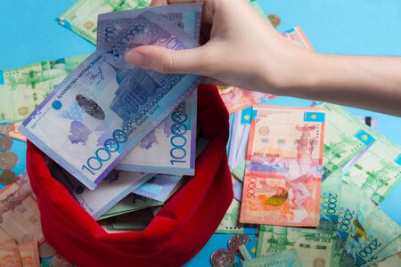 Person pulls the money out of the red bag. KZ. Kazakhstan, KZT. Pulling a lot of money out of the...