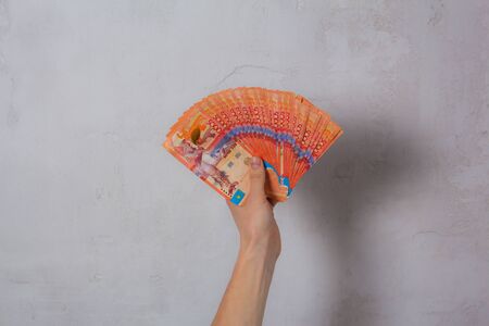 Hand hold a lot of money. Tenge KZT. National currency of Kazakhstan, KZ. Exchange rate. Economy, development, business, Bank, broker. Banknoteの写真素材