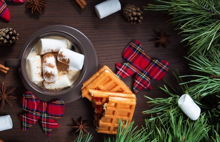 Christmas composition. A Cup of coffee and Vienna waffle, Christmas toys on a wooden background. The decoration of Christmas wreaths. Winter, new year concept. Flat lay, top view. Marshmallow. 2020の写真素材