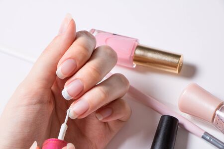 A woman paints her nails.の写真素材