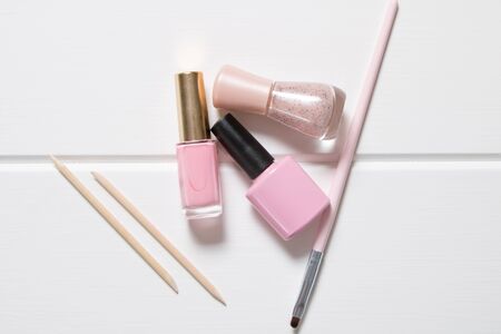 Manicure. Pink nail polishes on a whiteの写真素材