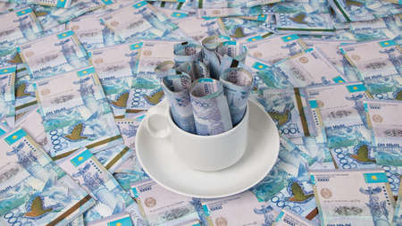Money in a Cup of coffee. Tenge, the national currency of Kazakhstan. Concept, living wage. Economy,...