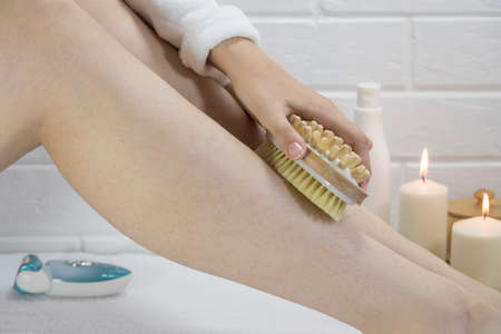 Exfoliation with a natural bristle brush. Dry brush massage. Preparing the skin for epilation....