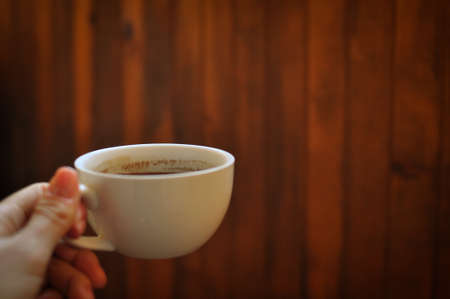 Brewed coffee cup on brown backgroundの写真素材