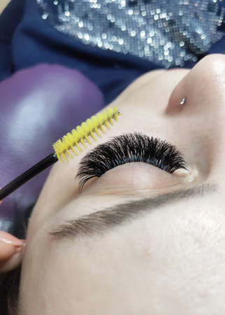 Lash extensions in beauty salon macro eye with rhinestones top view