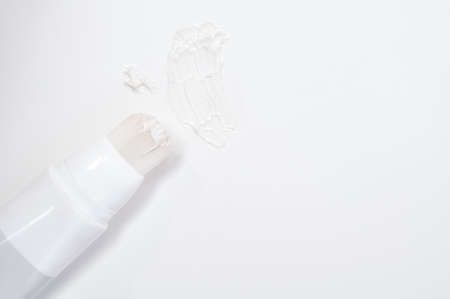 Dab of cream and brush for face on white backgroundの写真素材