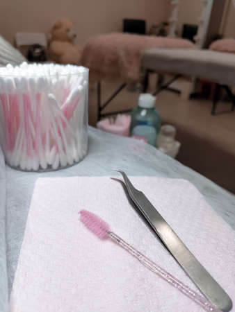 Tweezers and pink brush for lash extensions. Equipment for lashmaker in beauty salonの写真素材