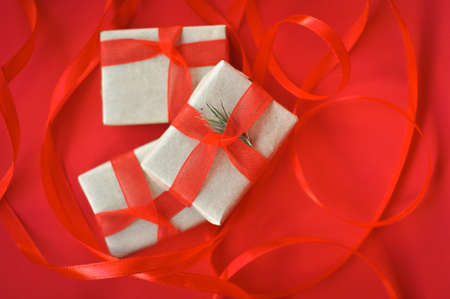 gift in wrapped paper on red background holiday mood
