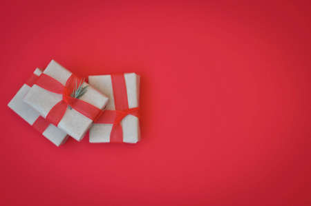 gift in wrapped paper on red background holiday moodの写真素材