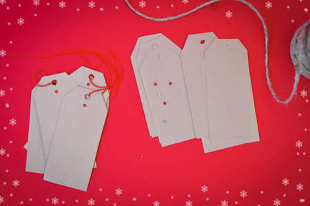 chritmas tags for presents on red backgroundの写真素材