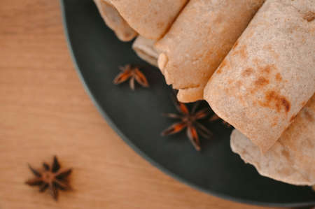 Rolled pancakes with apple cinnamon and honeyの写真素材
