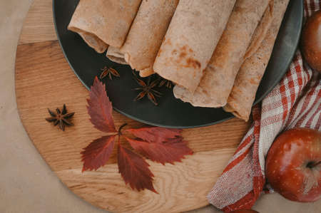 Rolled pancakes with apple cinnamon and honeyの写真素材