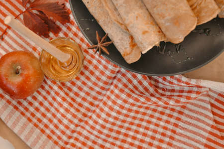 Rolled pancakes with apple cinnamon and honey