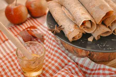 Rolled pancakes with apple cinnamon and honeyの写真素材
