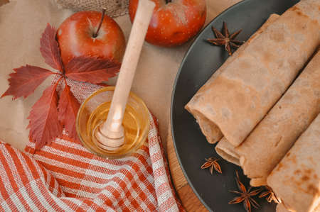 Rolled pancakes with apple cinnamon and honeyの写真素材