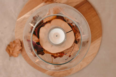 Autumn composition with golden leaves and candle . High quality photoの写真素材