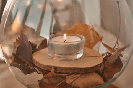Autumn composition with golden leaves and candle . High quality photoの写真素材