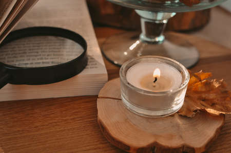 Autumn composition with golden leaves and candle . High quality photoの写真素材