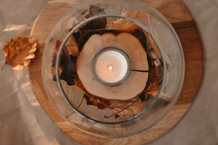 Autumn composition with golden leaves and candle . High quality photoの写真素材