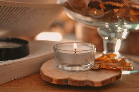 Autumn composition with golden leaves and candleの写真素材