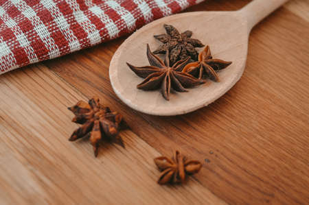 Cinnamon sticks and anise stars on the wooden spoon.asian spicesの写真素材