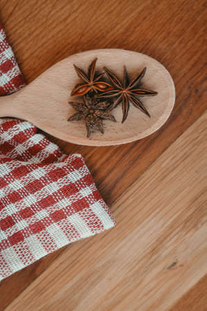 Cinnamon sticks and anise stars on the wooden spoon.asian spicesの写真素材