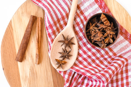 Cinnamon sticks and anise stars on the wooden spoon.asian spicesの写真素材