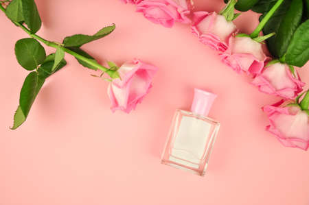 Rose perfume on pink background with flowersの写真素材