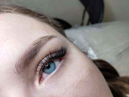 Lash extensions in beauty salon macro blue eyeの写真素材