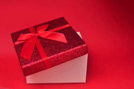 Present red box with bow giving gifts for holidays conceptの写真素材