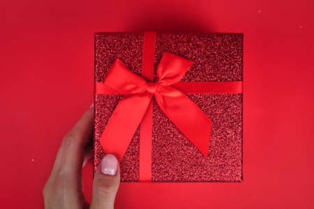 Present red box with bow giving gifts for holidays conceptの写真素材