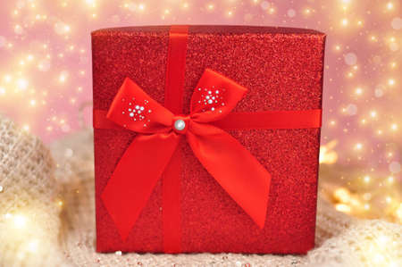 Present red box with bow giving gifts for holidays concept