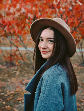 Portrait of young beautiful woman in brown hatの写真素材