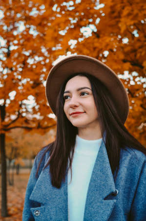 Portrait of young beautiful woman in brown hatの写真素材