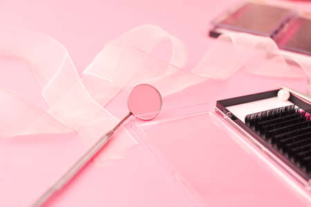 Equipment for eyelash extensions on pink background . High quality photoの写真素材