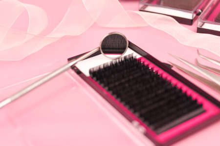 Equipment for eyelash extensions on pink background . High quality photoの写真素材