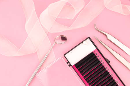 Equipment for eyelash extensions on pink background . High quality photoの写真素材