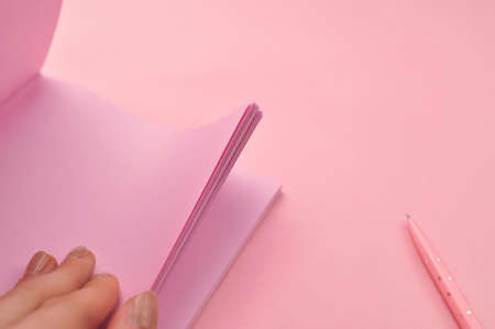 Making notes in pink notebook copy space . High quality photoの写真素材