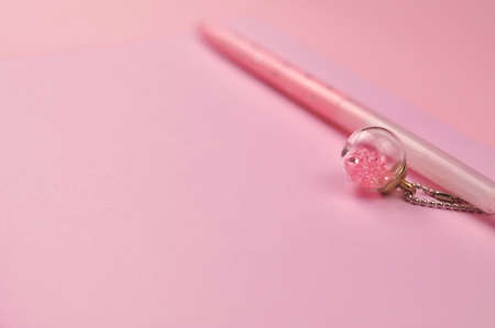 Making notes in pink notebook copy space . High quality photoの写真素材