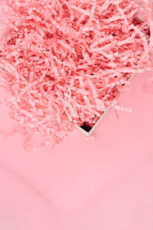 Calm pink background with tissue paper in present boxの写真素材