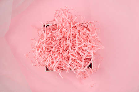Calm pink background with tissue paper in present boxの写真素材