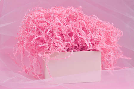 Calm pink background with tissue paper in present boxの写真素材