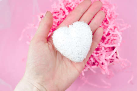 White heart on pink background love conceptの写真素材